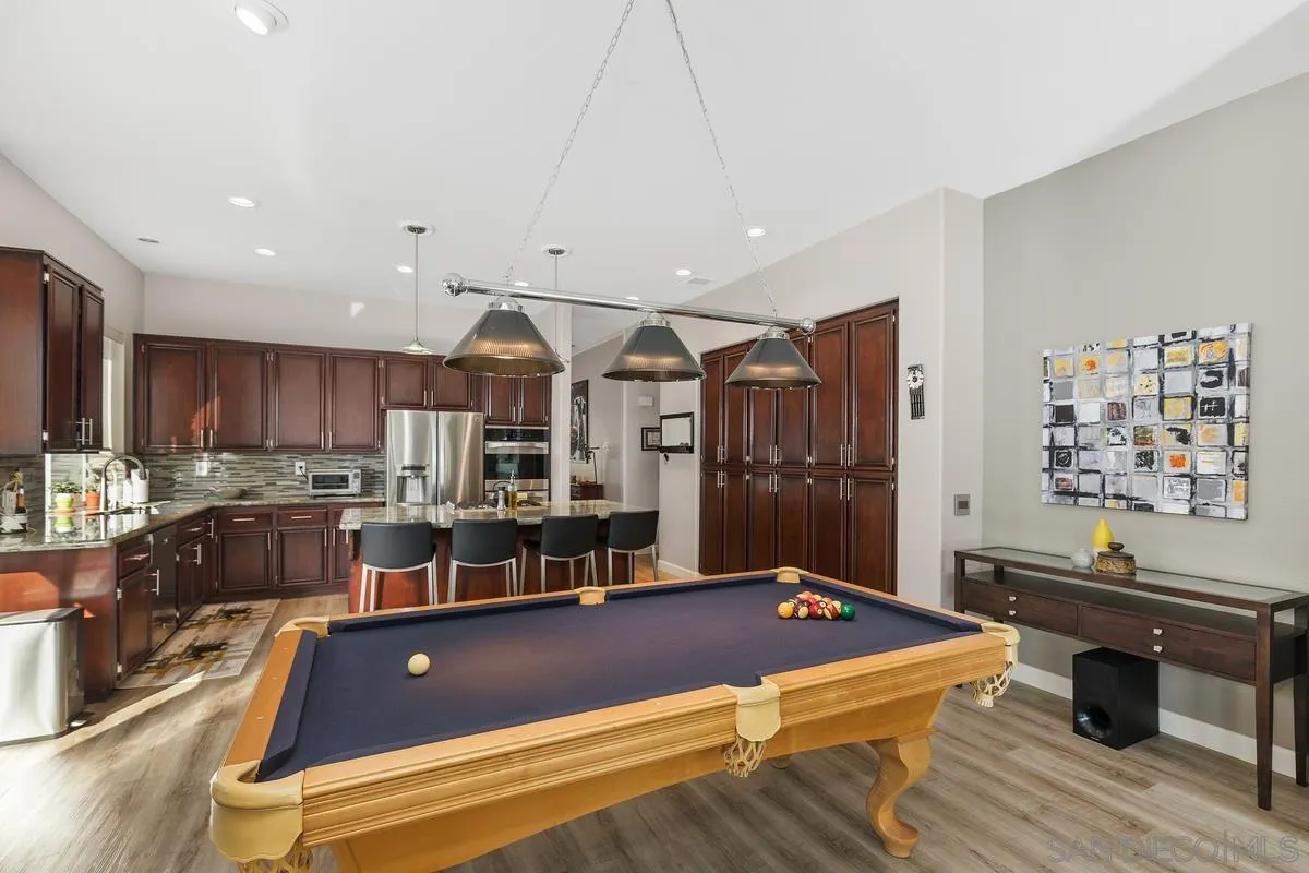45627 Caminito Olite Temecula, CA 92592 - Photo 13 of 24 a living room with stainless steel appliances kitchen island granite countertop furniture and a view of kitchen