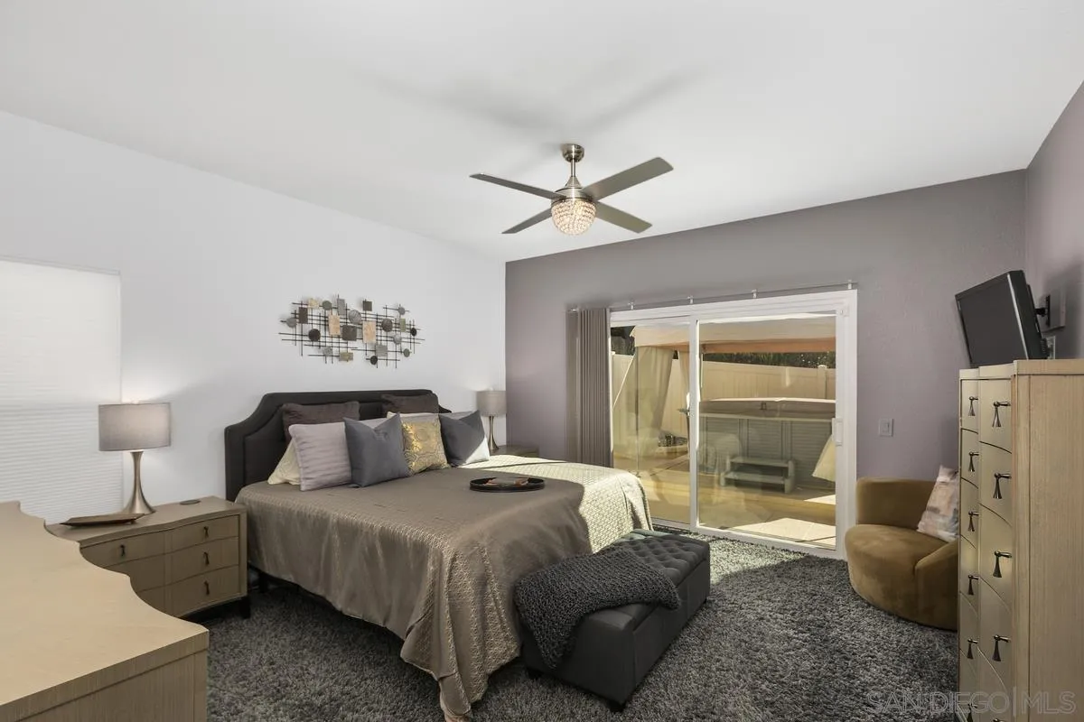 45627 Caminito Olite Temecula, CA 92592 - Photo 16 of 24 a bedroom with a bed and a chandelier