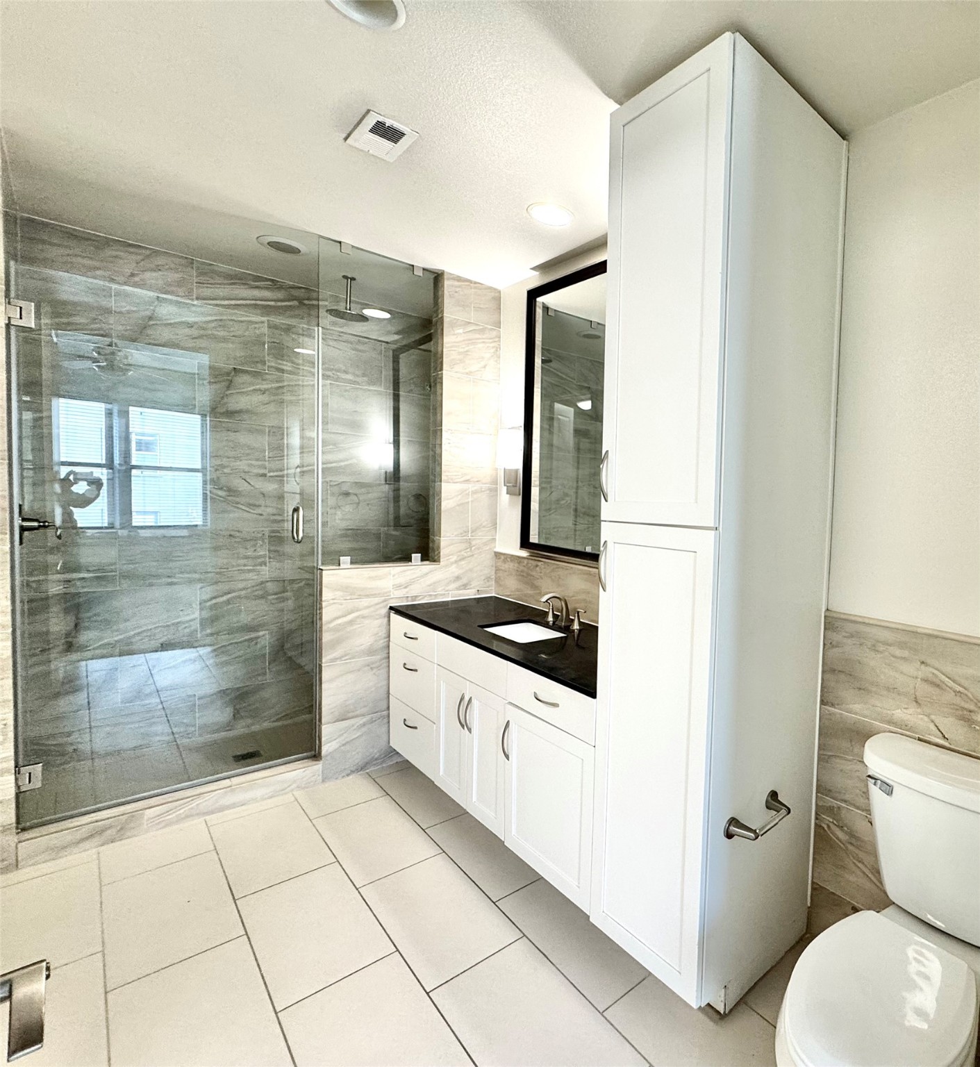 2303 Mid Lane, Unit 228 Houston, TX 77027 - Photo 10 of 30 a bathroom with a granite countertop sink mirror and toilet