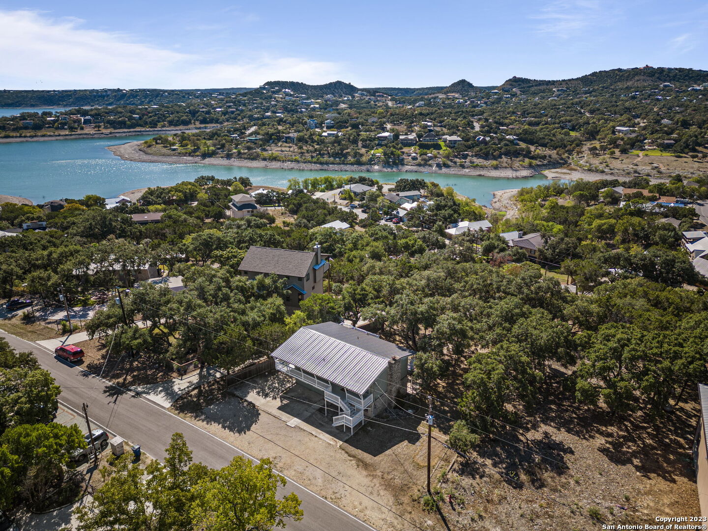 an aerial view of residential house with outdoor space and lake view
