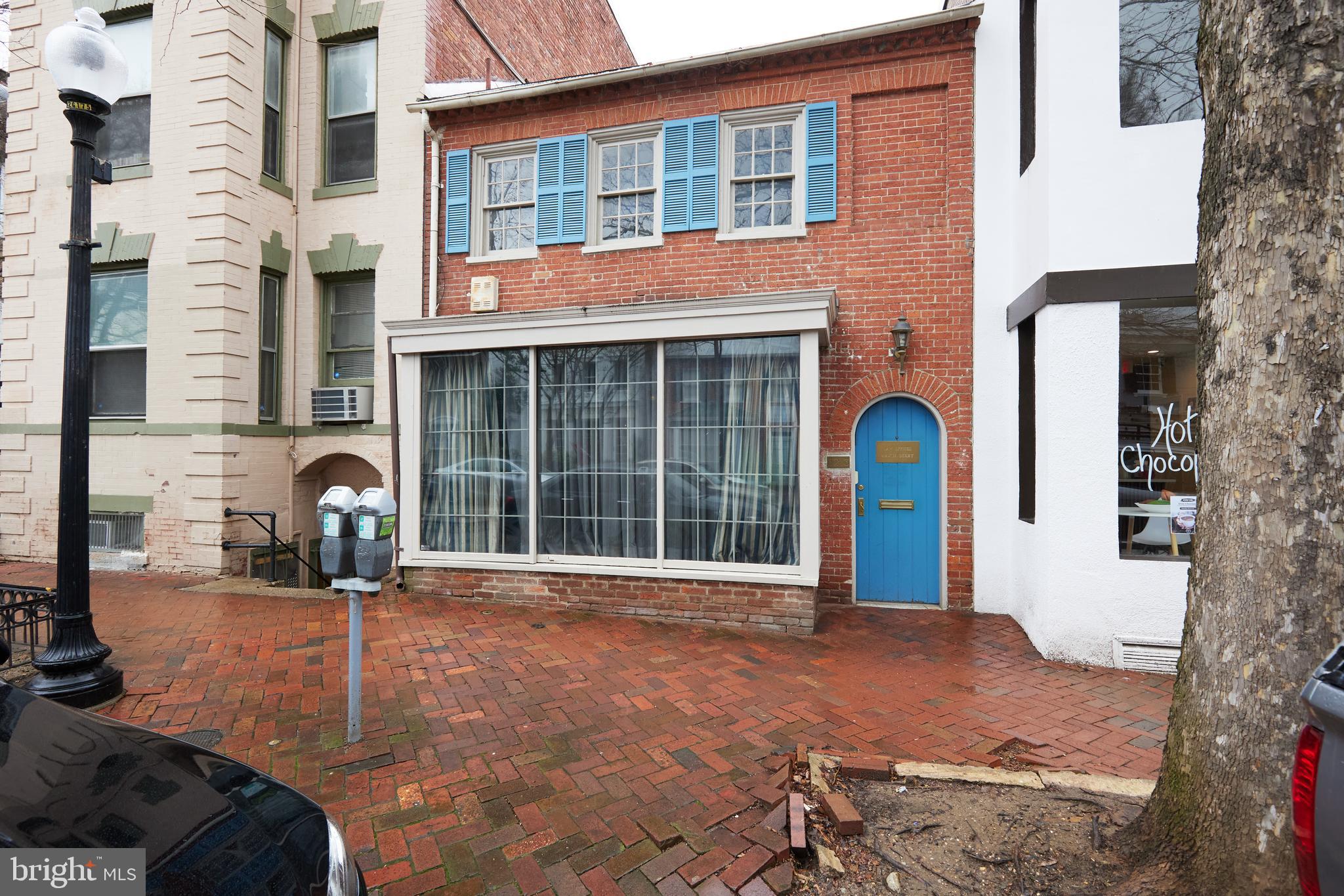 a front view of a house with parking area