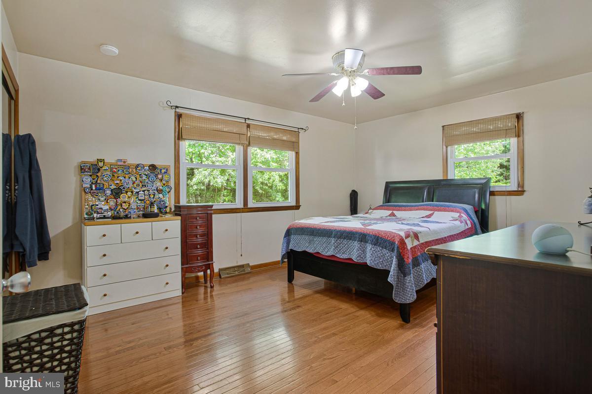 6600 Ashland Road La Plata, MD 20646 - Photo 19 of 40 a bedroom with a bed and a flat tv screen on dresser