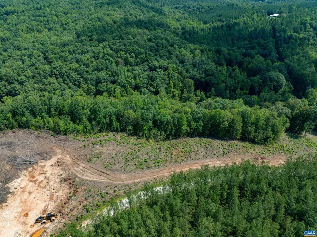 a view of a field of grass and trees