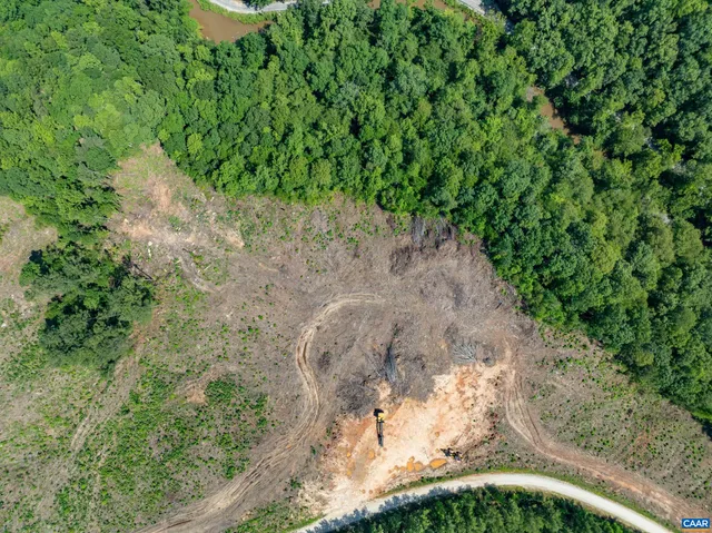 a view of a big yard with lots of green space