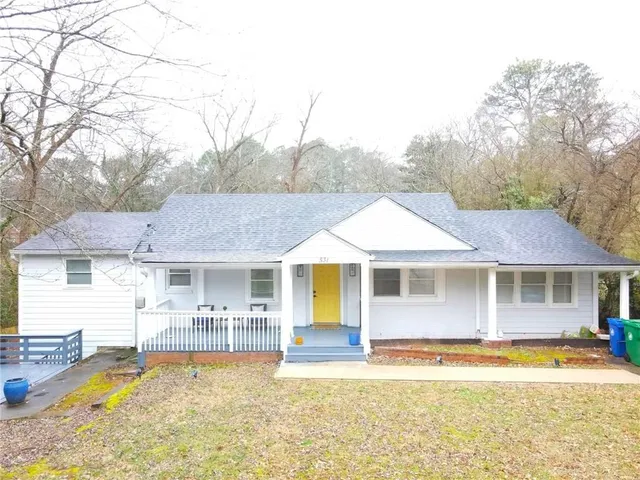 a front view of a house with swimming pool and porch
