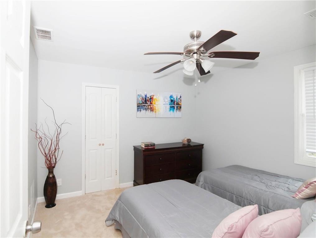 531 Allendale Drive Decatur, GA 30032 - Photo 19 of 19 a bedroom with a bed and a chandelier