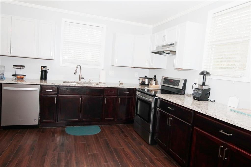 531 Allendale Drive Decatur, GA 30032 - Photo 7 of 19 a kitchen with a sink a stove cabinets and wooden floor