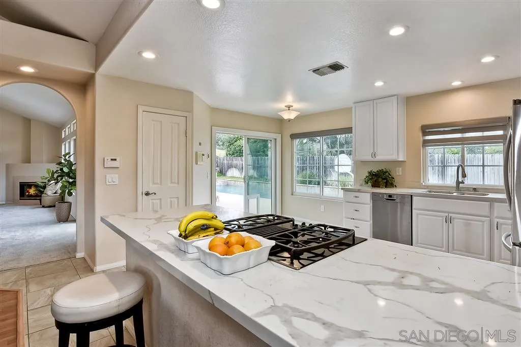 13603 Sunset View Road Poway, CA 92064 - Photo 11 of 25 a kitchen with stainless steel appliances granite countertop a sink stove and cabinets