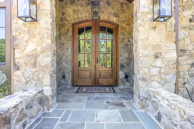 a living room with furniture a rug and a fireplace