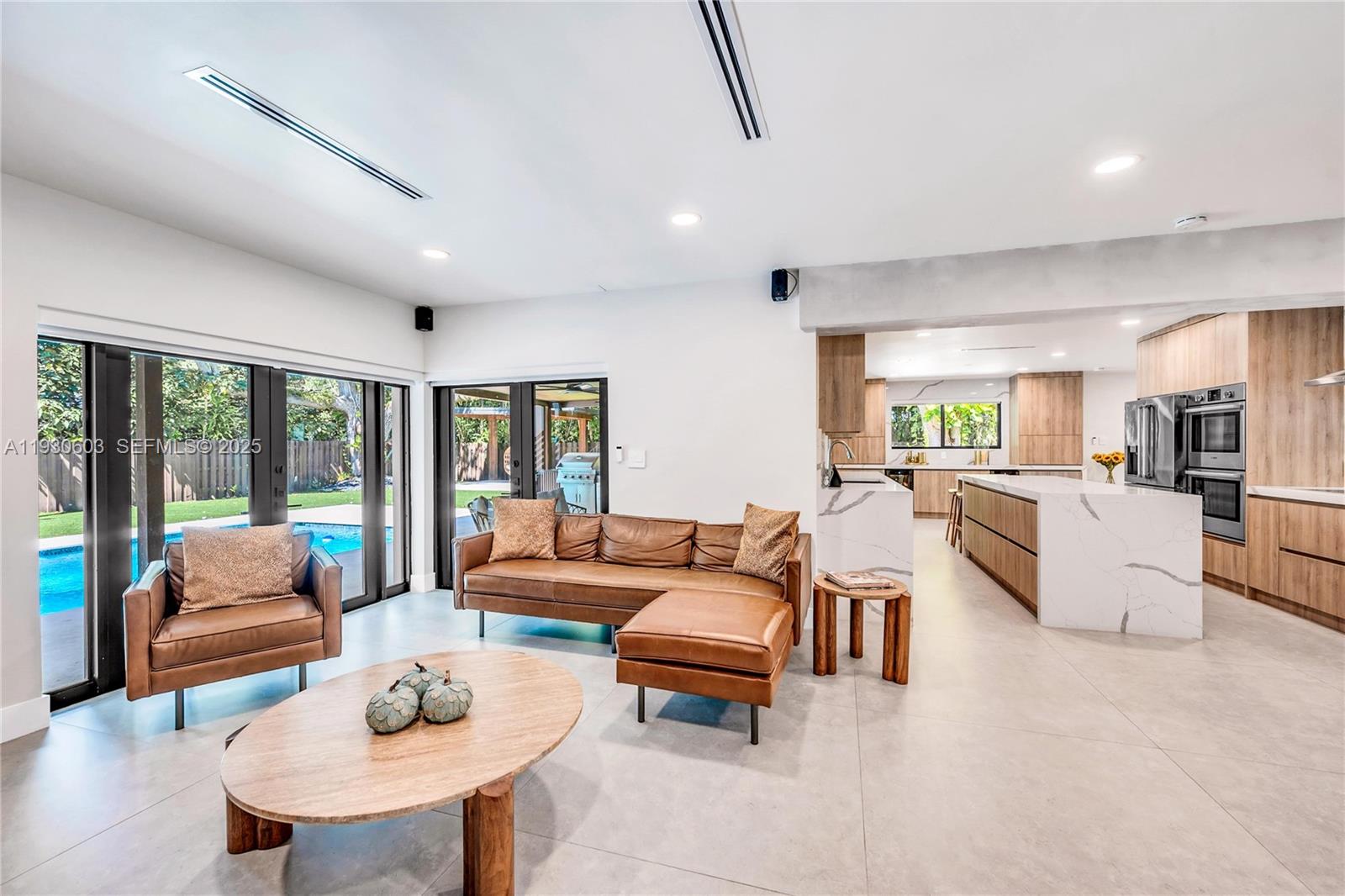11340 Southwest 74th Court Pinecrest, FL 33156 - Photo 13 of 91 a living room with furniture and a large window