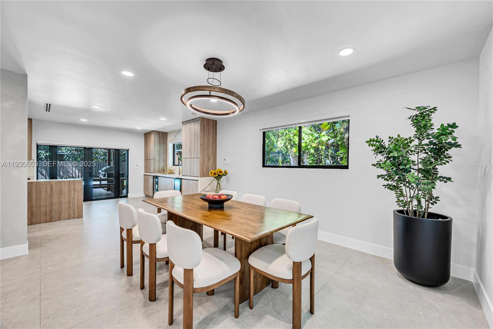 11340 Southwest 74th Court Pinecrest, FL 33156 - Photo 18 of 91 a view of a dining room with furniture and a potted plant