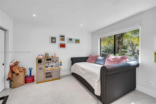a bedroom with furniture and a flat screen tv