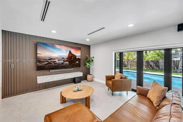 a bedroom with furniture and a flat screen tv