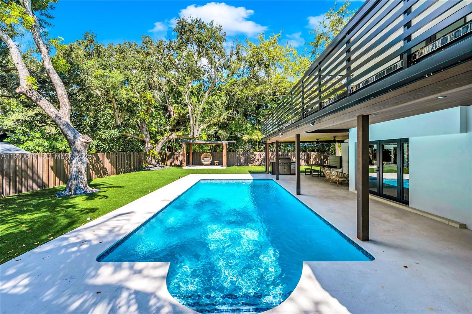 11340 Southwest 74th Court Pinecrest, FL 33156 - Photo 31 of 91 a view of a swimming pool with a patio