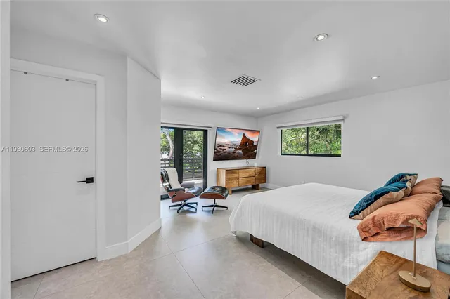 a view of a backyard with table and chairs under an umbrella
