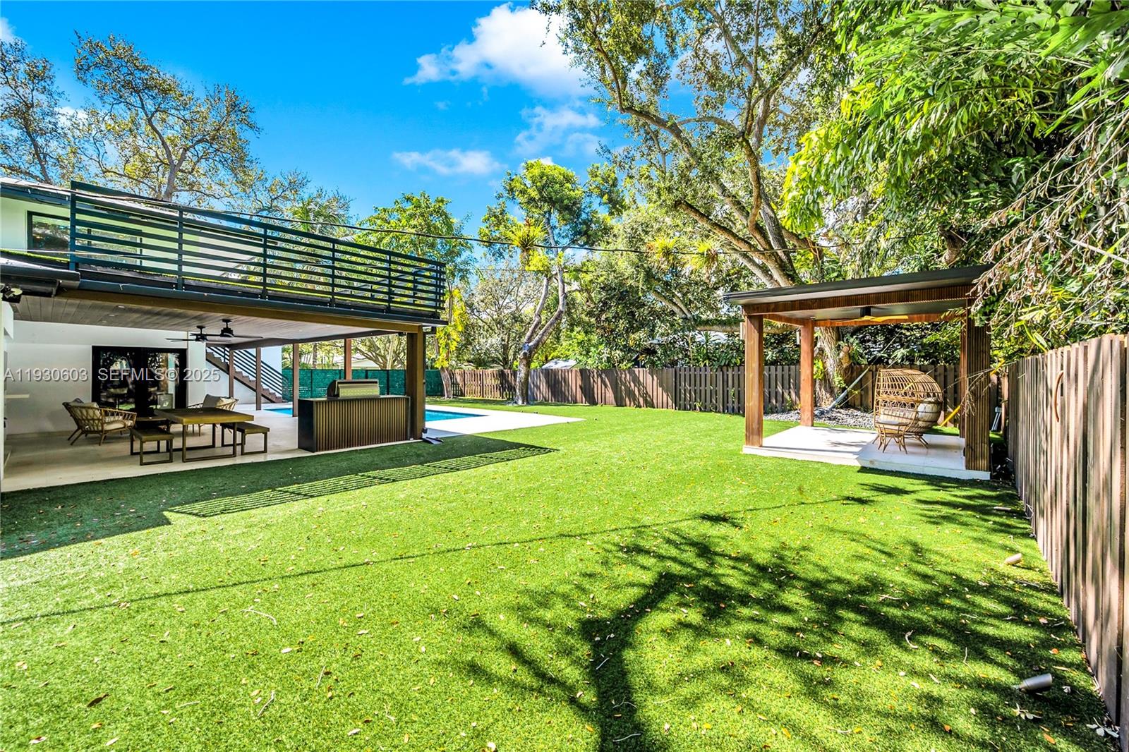 11340 Southwest 74th Court Pinecrest, FL 33156 - Photo 37 of 91 a view of a house with backyard porch and sitting area