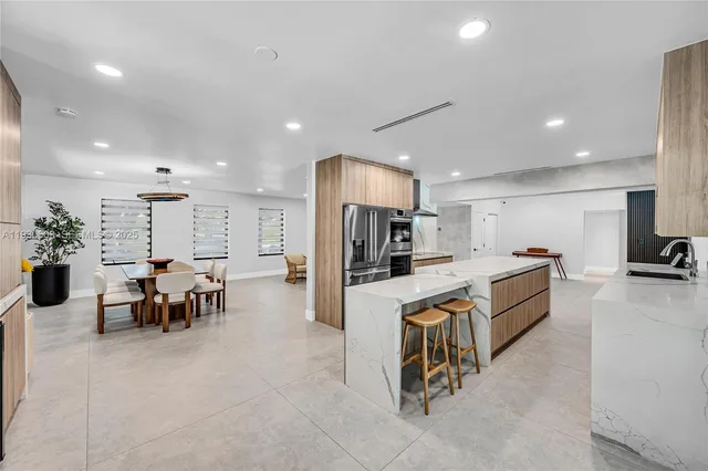 an aerial view of a house with a yard swimming pool and outdoor seating