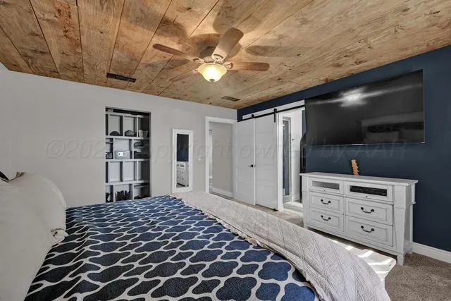 a bedroom with a bed and a television