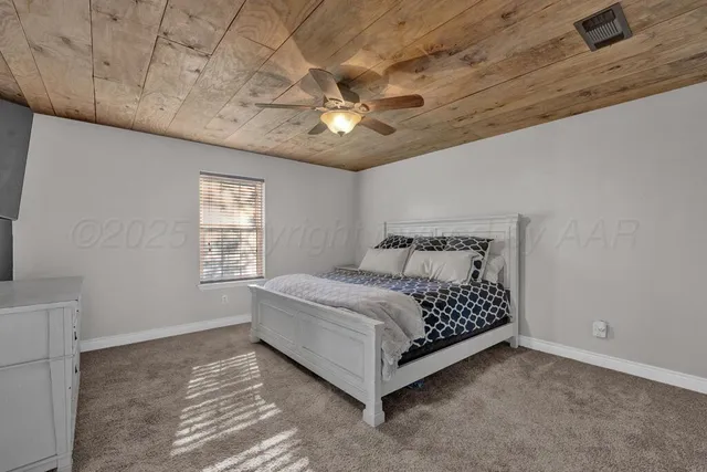 a spacious bedroom with a bed and a window