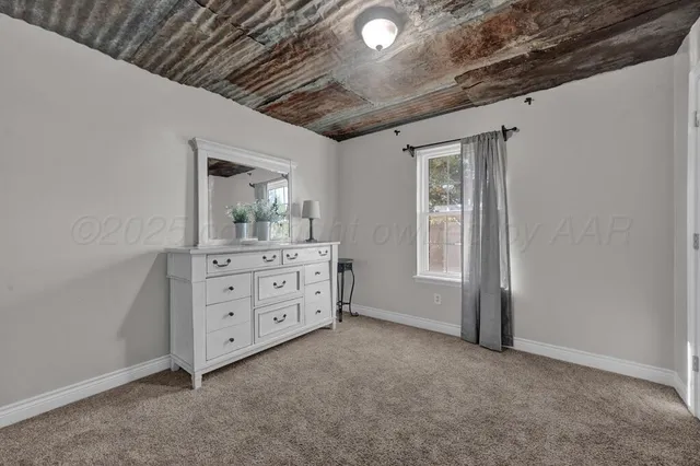 a room with a dresser and a mirror