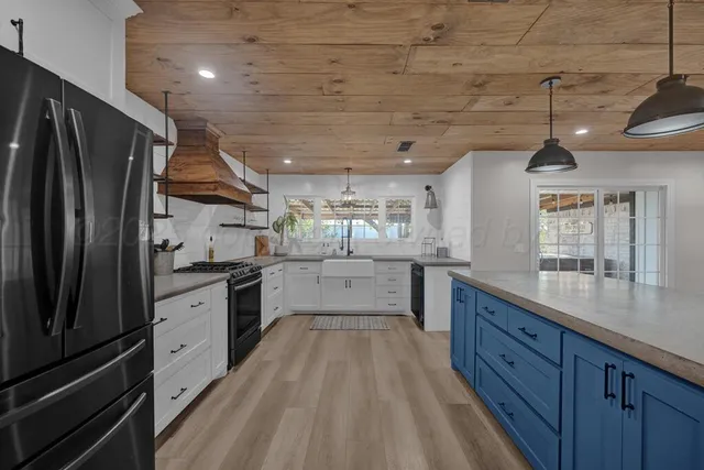 a large kitchen with cabinets and stainless steel appliances