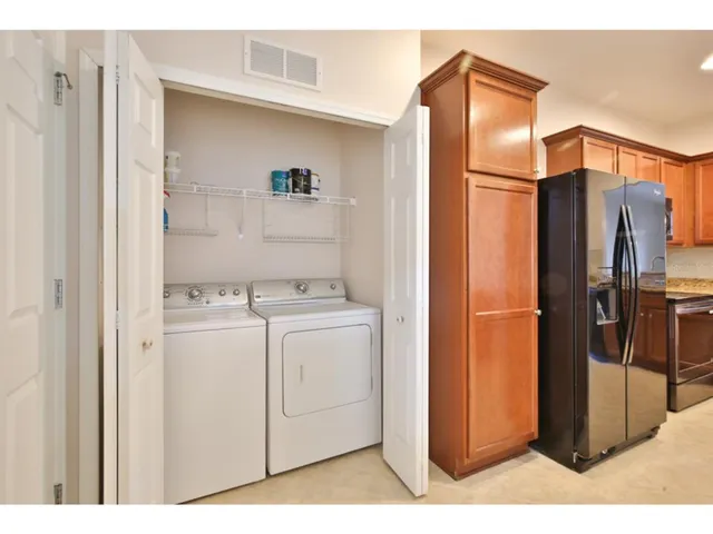 a kitchen with a refrigerator and cabinets