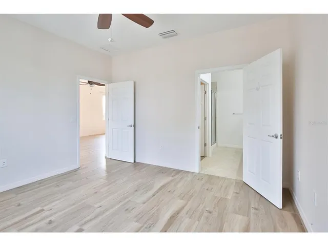 a view of an empty room with wooden floor