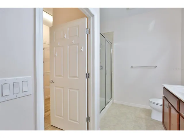 a bathroom with a double vanity sink a toilet and a mirror