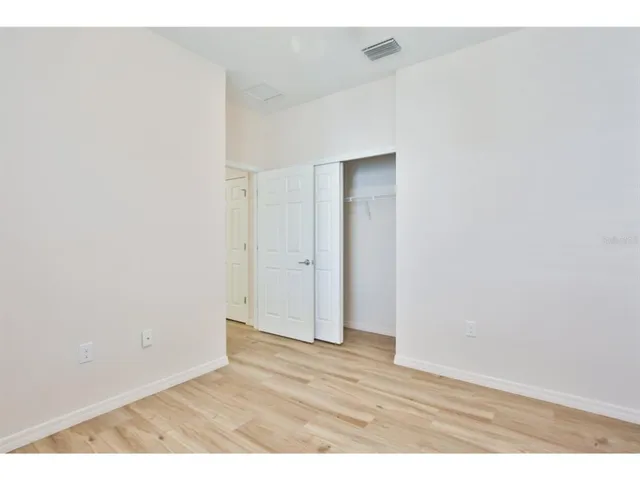 a bathroom with a sink a toilet a mirror and shower