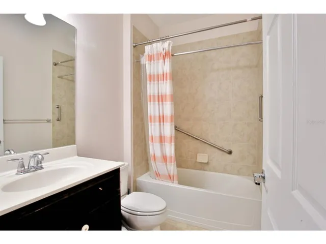 a view of an empty room with floor to ceiling windows