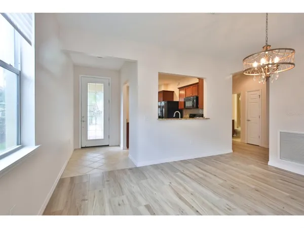 a view interior of a house with wooden floor a fireplace and windows