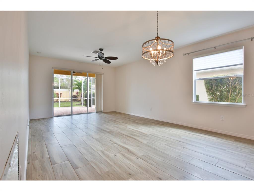 19108 Lappacio Street Venice, FL 34293 - Photo 6 of 33 a view of an empty room with wooden floor and a window