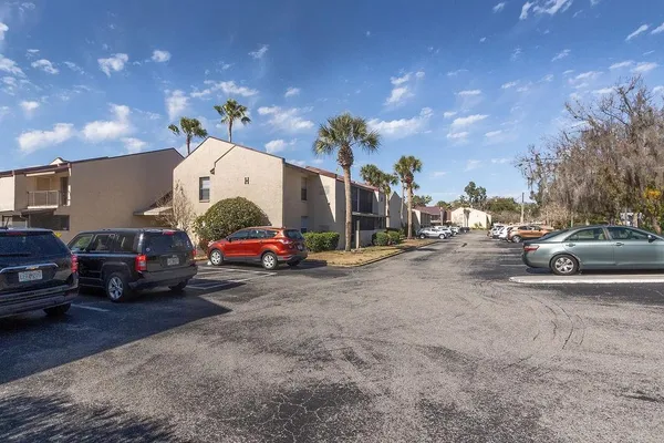 a view of cars parked in front of a house