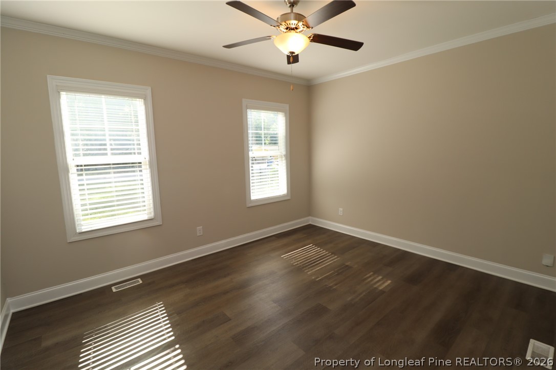 8424 Rhodes Road Apex, NC 27539 - Photo 18 of 31 a view of an empty room with wooden floor and a window