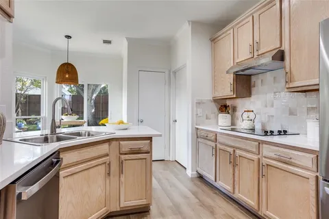 a kitchen with cabinets a sink and appliances