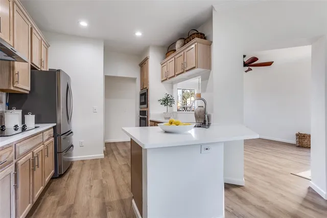 a kitchen with stainless steel appliances a sink stove and refrigerator