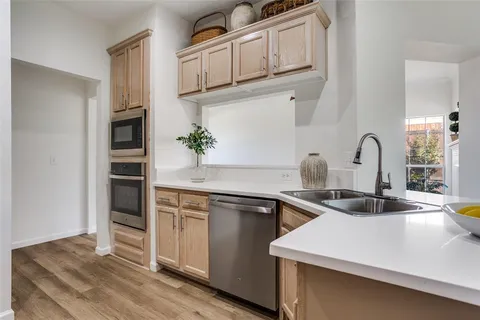 a kitchen with white cabinets appliances and a sink