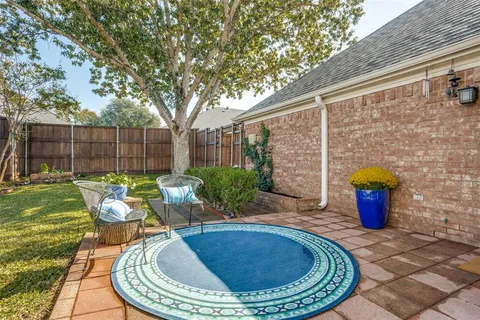 a view of a backyard with sitting area and garden
