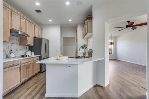 a kitchen with stainless steel appliances a sink stove and refrigerator