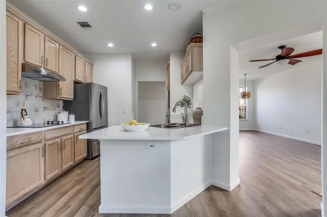 a kitchen with stainless steel appliances a sink stove and refrigerator