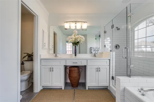 a spacious bathroom with a granite countertop sink a toilet and shower