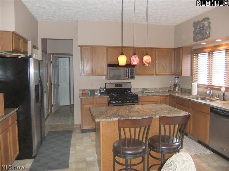 3795 Stonebridge Boulevard Akron, OH 44321 - Photo 5 of 24 The foyer offers an open flow into the center of the home and leads into the spacious kitchen with eating area.