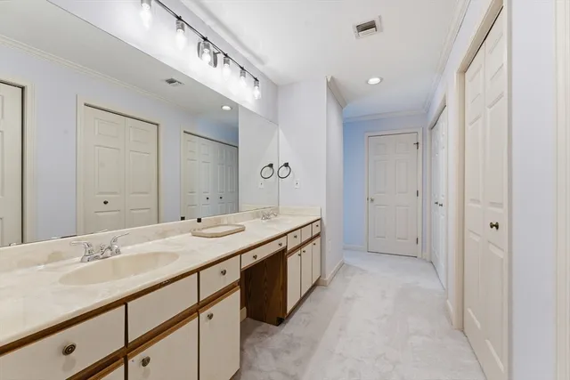 a bathroom with a sink double vanity and a mirror