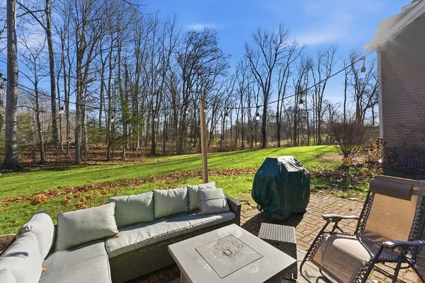 a view of a backyard with furniture and garden