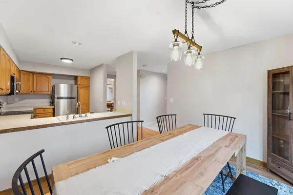 a view of a hallway with furniture and wooden floor