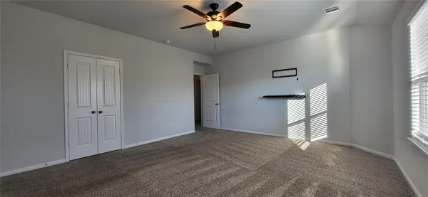 a view of a livingroom with a ceiling fan & window
