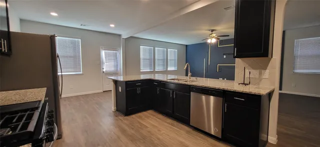a kitchen with granite countertop a refrigerator and a sink