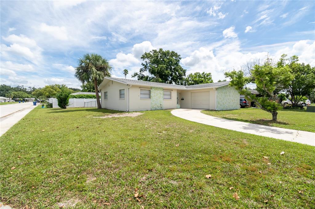 7102 Hollybay Road New Port Richey, FL 34653 - Photo 1 of 1 a view of a house with a yard