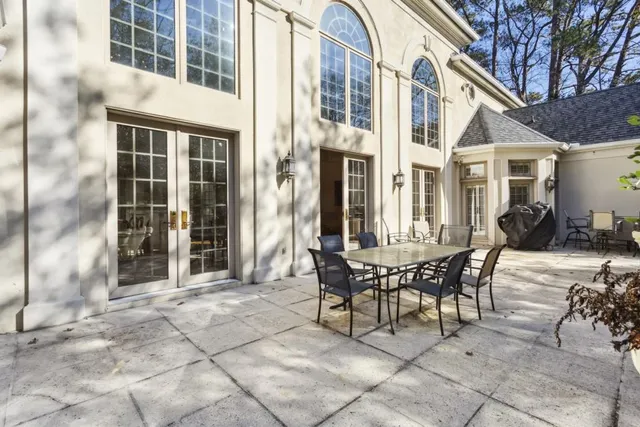 a large kitchen with lots of counter top space and dining table