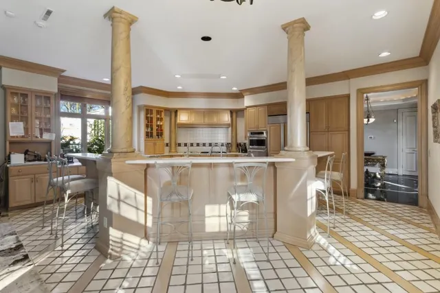 a large kitchen with a table and chairs